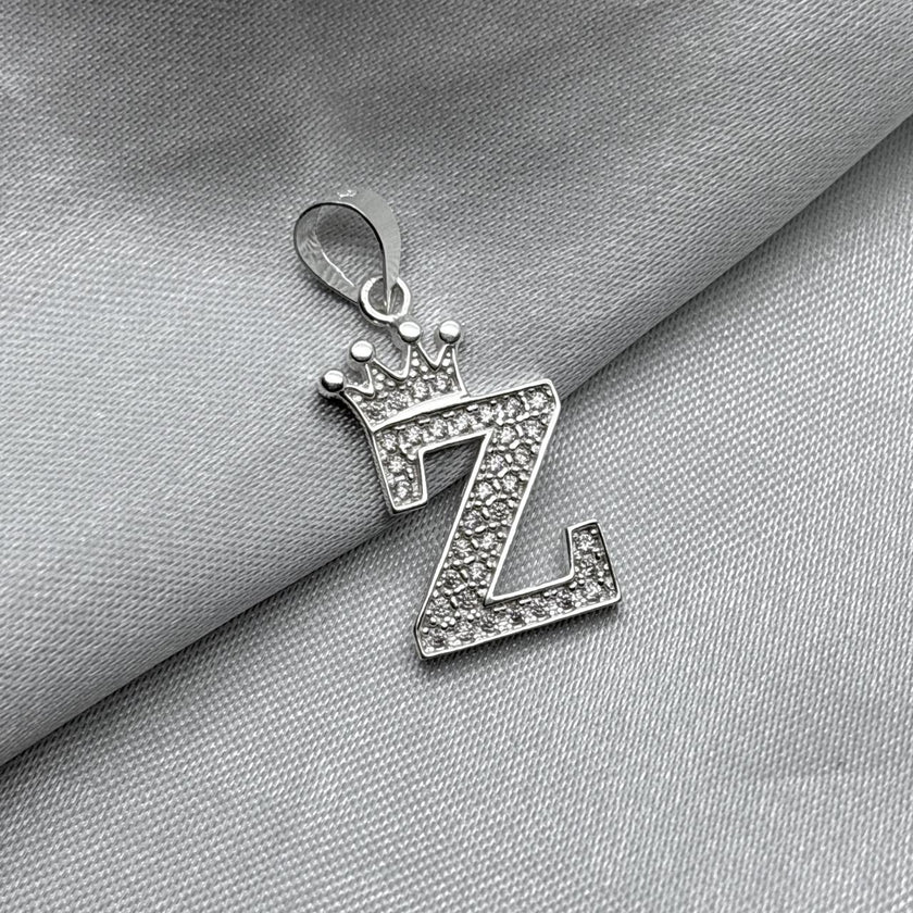 #D593 - Dije Letras Con Corona Y Piedra Zirconia Plata - A09/2.5